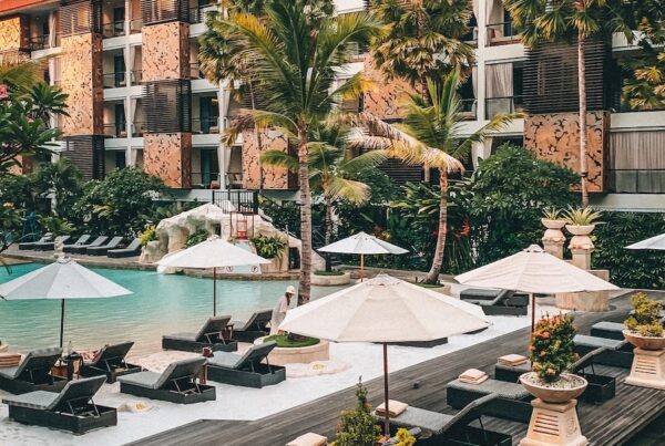 white patio umbrella near swimming pool during daytime